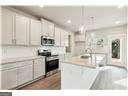 kitchen featuring appliances with stainless steel finishes and white cabinets