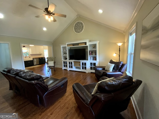 living room featuring lofted ceiling, dark wood-type flooring, ornamental molding, and ceiling fan