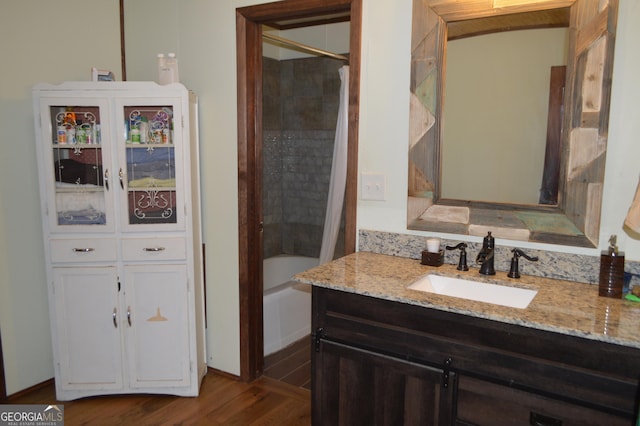 bathroom with vanity, hardwood / wood-style flooring, and shower / bath combo