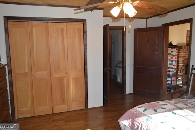 bedroom featuring dark hardwood / wood-style floors, wooden ceiling, and ceiling fan