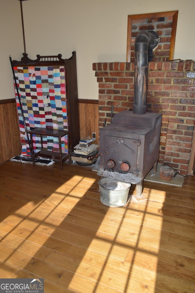 room details featuring hardwood / wood-style flooring and a wood stove