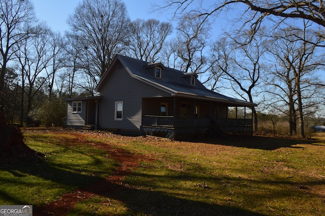 back of house featuring a porch and a yard