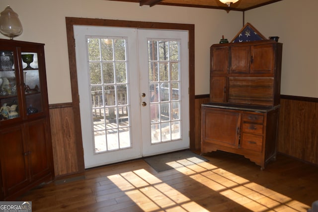 doorway with beamed ceiling, wood-type flooring, and french doors