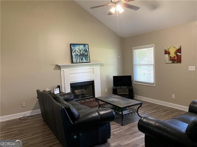 living room featuring ceiling fan, lofted ceiling, and wood-type flooring