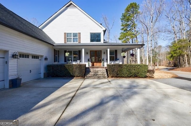 view of front of property featuring covered porch, concrete driveway, and a garage