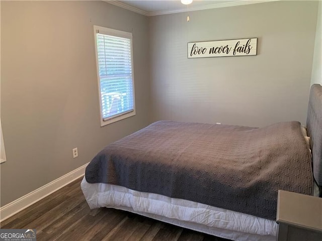 bedroom with ornamental molding and dark hardwood / wood-style floors