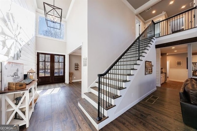 foyer entrance with dark wood-type flooring, visible vents, stairs, ornamental molding, and french doors