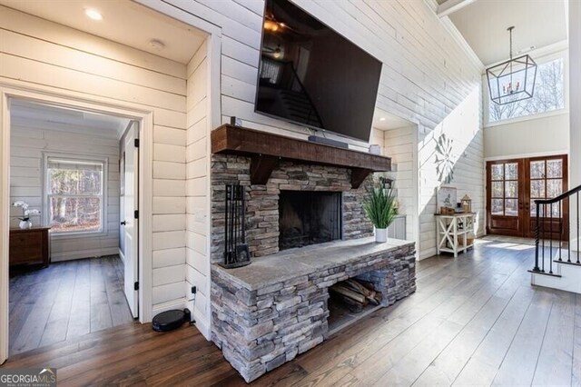 3055 Spring Hill Dr, Monroe, GA 30656 - living room featuring a fireplace, hardwood / wood-style floors, stairs, wood walls, and a high ceiling