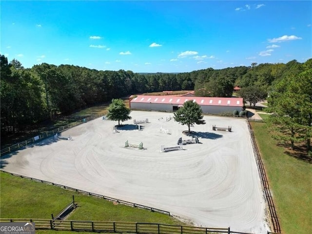 birds eye view of property with a view of trees