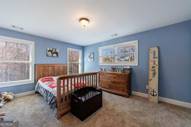 carpeted bedroom with baseboards and visible vents