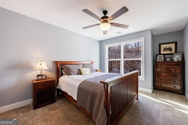 bedroom with visible vents, baseboards, ceiling fan, and light colored carpet