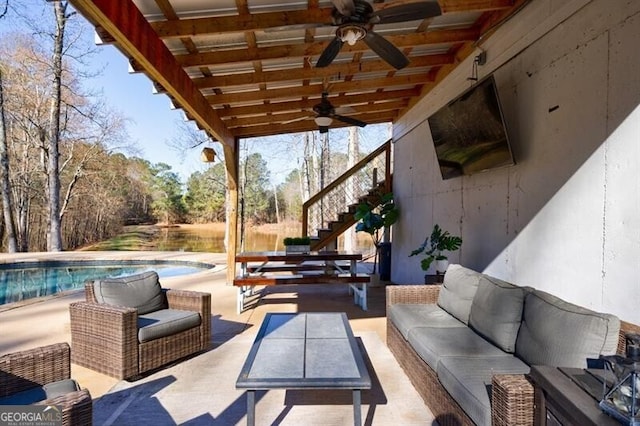 view of patio / terrace featuring outdoor lounge area, an outdoor pool, and stairs