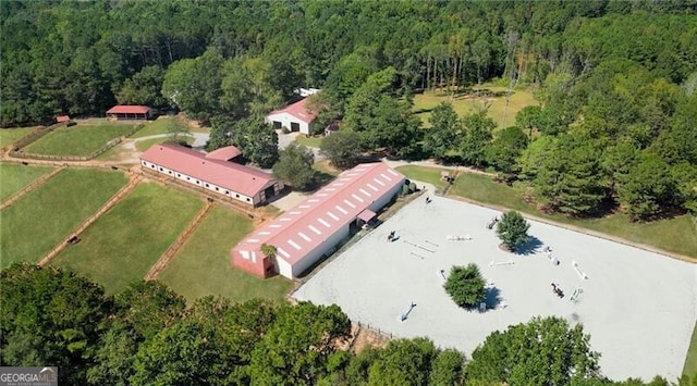 birds eye view of property with a view of trees