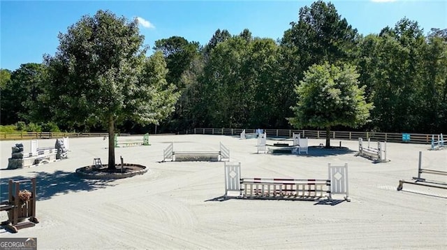 view of property's community featuring an enclosed area and fence