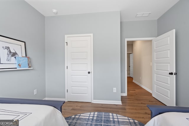 bedroom with dark hardwood / wood-style floors