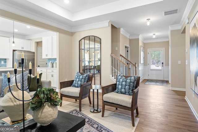 interior space with ornamental molding and light wood-type flooring