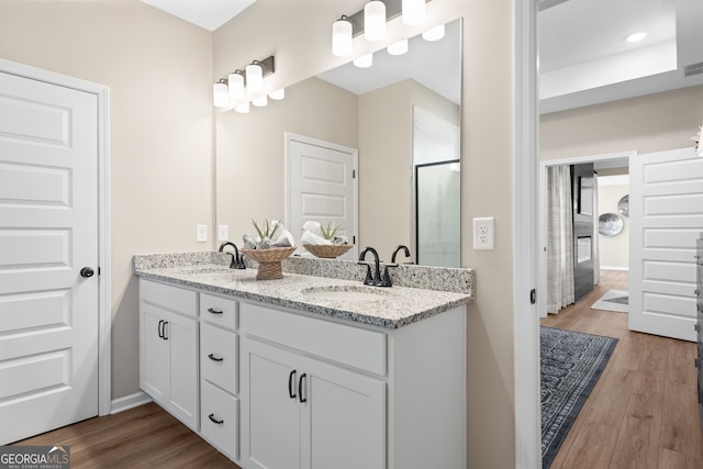 bathroom featuring vanity, an enclosed shower, and hardwood / wood-style flooring