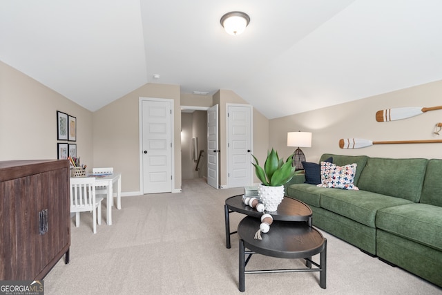 carpeted living room featuring vaulted ceiling