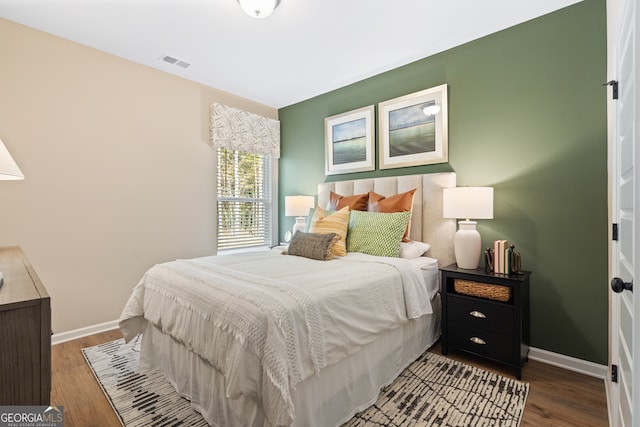 bedroom with hardwood / wood-style floors