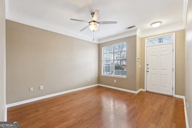 entrance foyer with ceiling fan, ornamental molding, and hardwood / wood-style floors