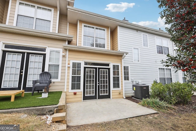 back of property featuring a patio and central air condition unit