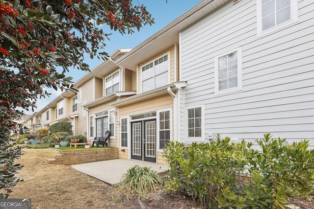 rear view of property featuring a patio area