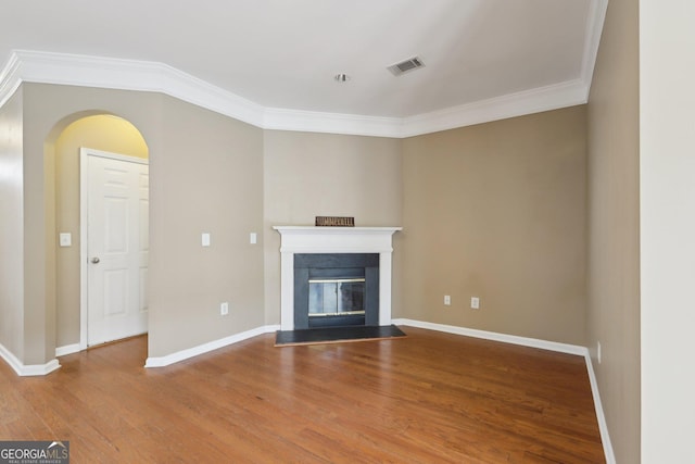 unfurnished living room featuring hardwood / wood-style flooring and ornamental molding