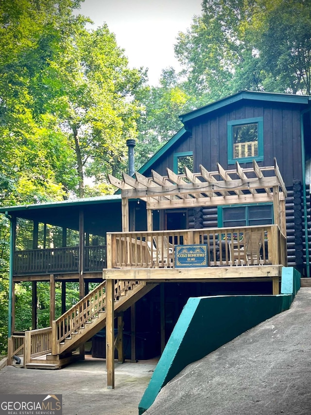 back of house with a deck and a pergola