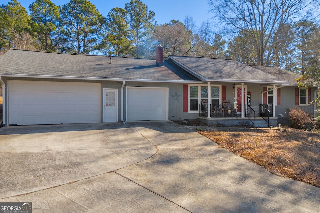 single story home with a garage and covered porch