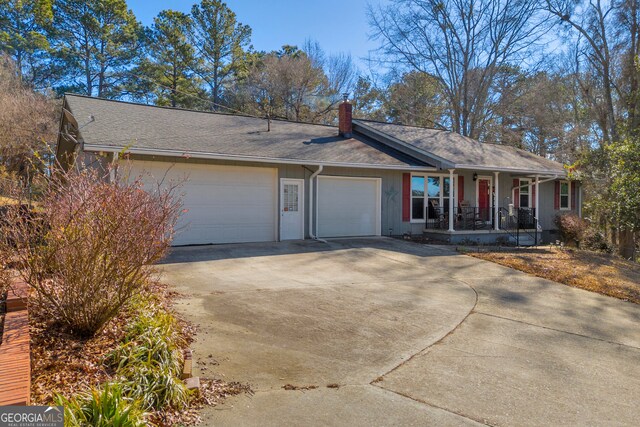 ranch-style home with a garage and covered porch