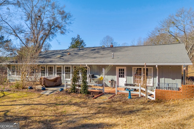 back of property featuring a lawn