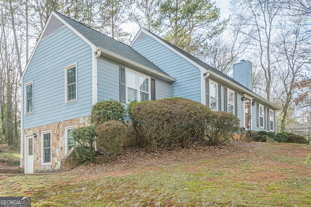 view of property exterior with a lawn