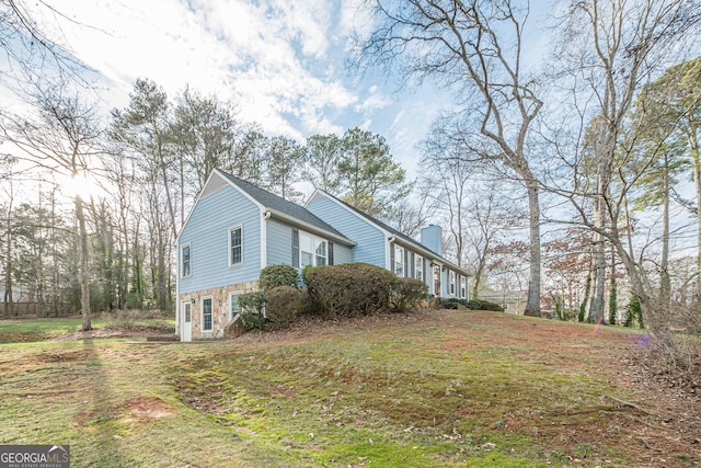 view of property exterior featuring a lawn