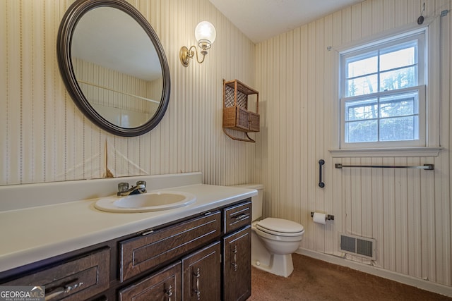 bathroom featuring vanity and toilet