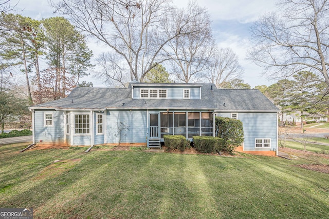 back of house featuring a lawn and a sunroom