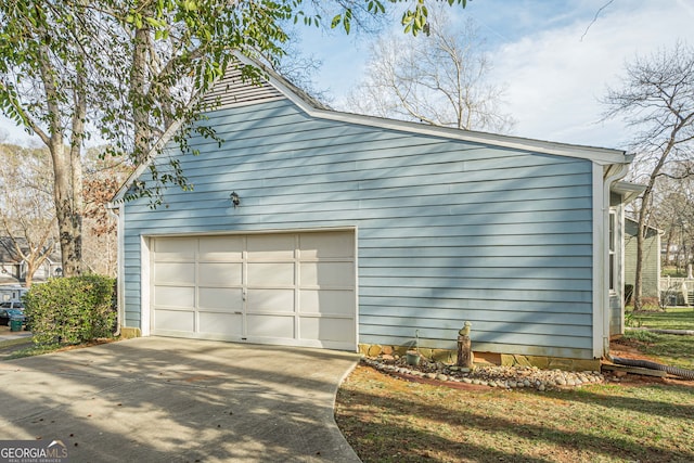 view of side of home featuring an outbuilding and a garage