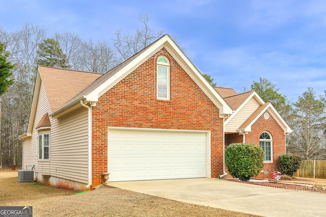 front facade featuring cooling unit and a garage