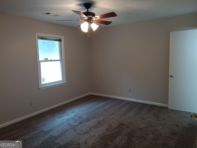 empty room with ceiling fan and carpet