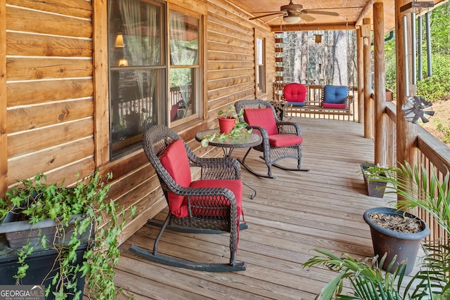 wooden terrace featuring ceiling fan and covered porch