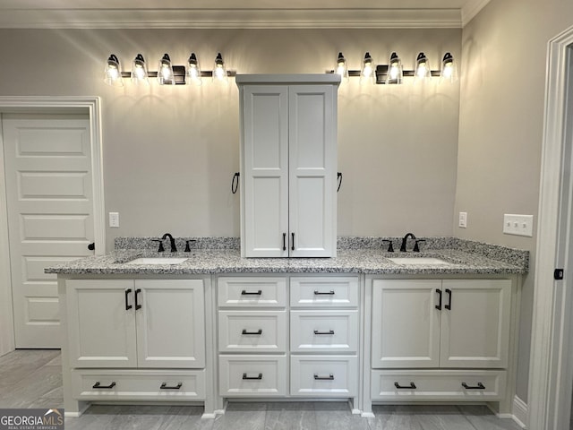 bathroom with vanity and ornamental molding