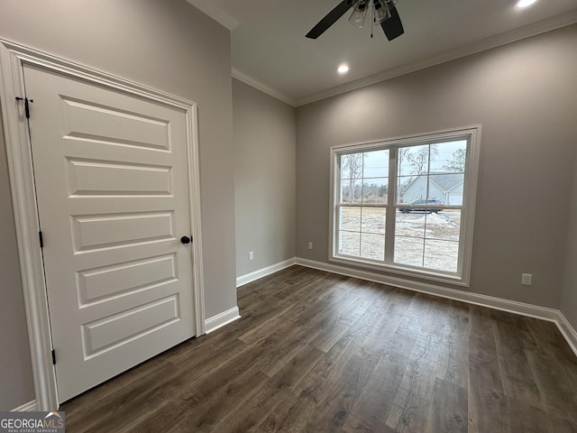 unfurnished room with crown molding, ceiling fan, and dark wood-type flooring