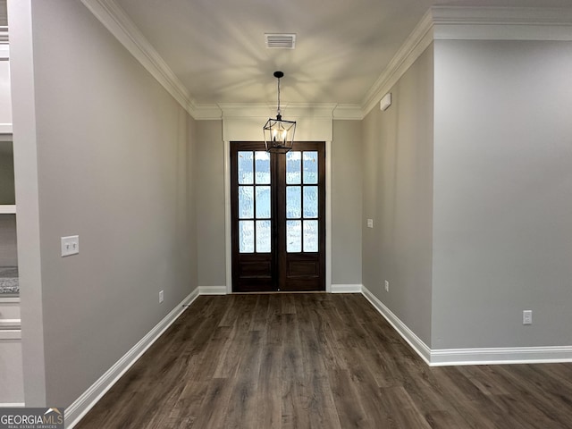 foyer entrance featuring crown molding, dark hardwood / wood-style flooring, a chandelier, and french doors