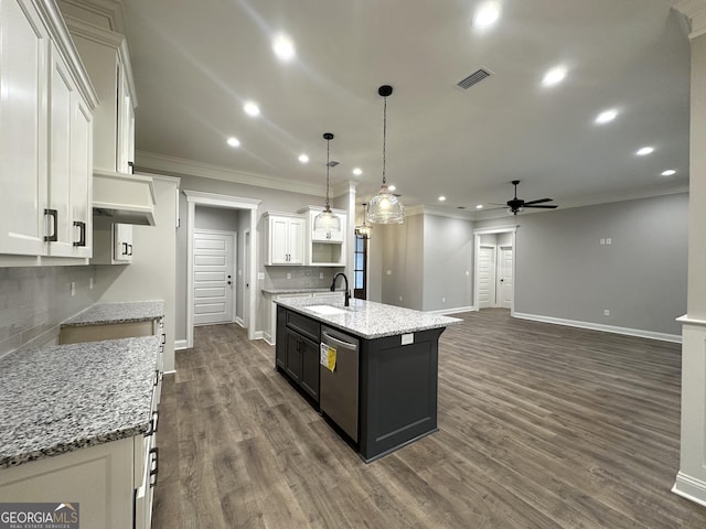 kitchen featuring dishwasher, white cabinets, a center island with sink, dark hardwood / wood-style flooring, and decorative light fixtures