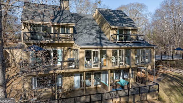 rear view of house featuring a balcony and outdoor lounge area