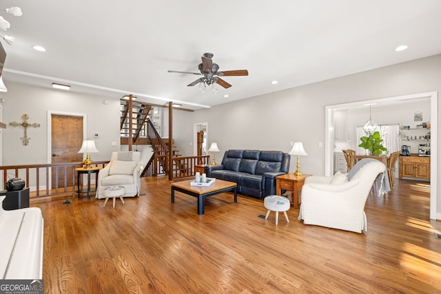 living room featuring light hardwood / wood-style floors and ceiling fan