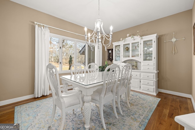 dining space featuring an inviting chandelier and dark hardwood / wood-style floors