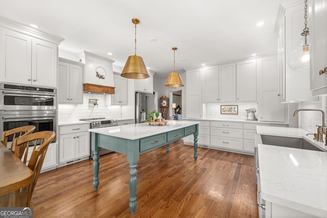 kitchen with white cabinetry, sink, pendant lighting, and appliances with stainless steel finishes