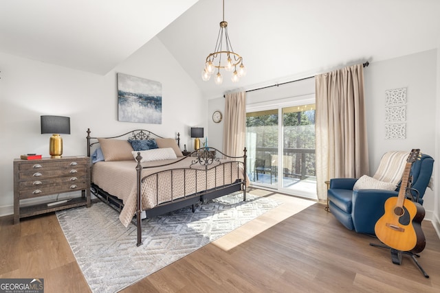 bedroom with an inviting chandelier, wood-type flooring, vaulted ceiling, and access to outside