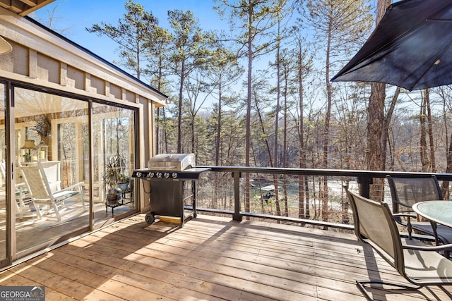 wooden deck featuring a grill