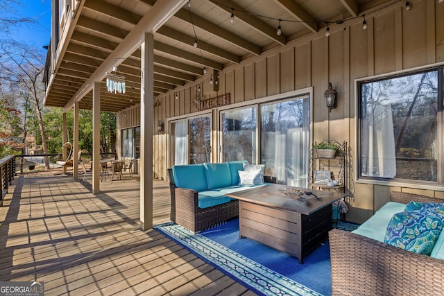 wooden terrace with an outdoor hangout area